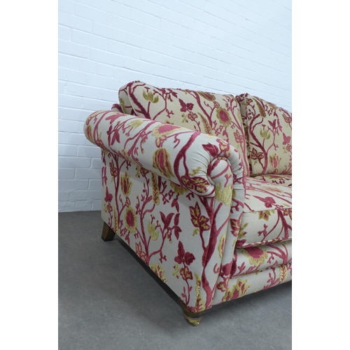 278 - Modern two seater scroll arm sofa with floral upholstery, wooden legs with brass caps and castors 20... 