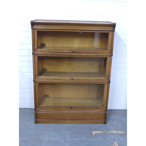 281 - Inglesants oak three tier sectional bookcase, with glass fronts and brass label, 87 x 120 x 31cm