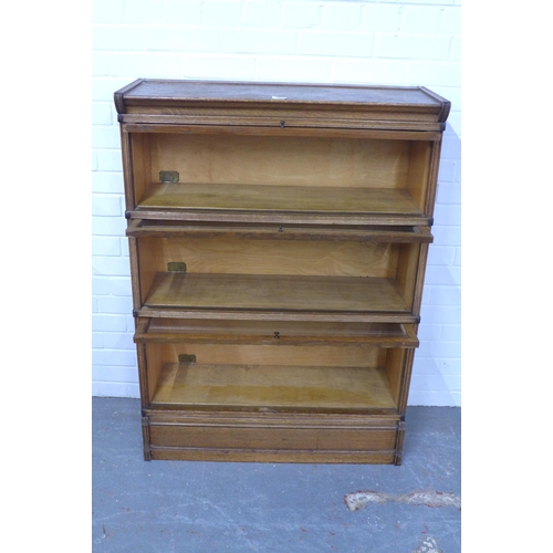 281 - Inglesants oak three tier sectional bookcase, with glass fronts and brass label, 87 x 120 x 31cm