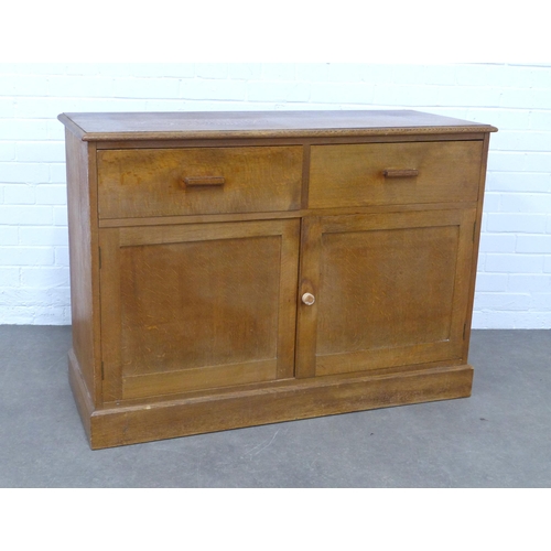 283 - An early 20th century light oak two door cupboard, 118 x 84 x 47cm.