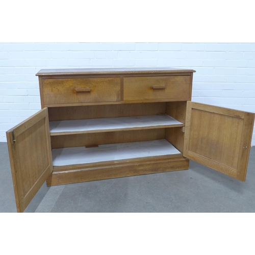 283 - An early 20th century light oak two door cupboard, 118 x 84 x 47cm.