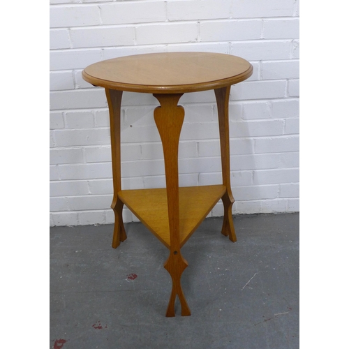 317 - An Arts & Crafts oak table, circular top and underier, 50 x 75cm.