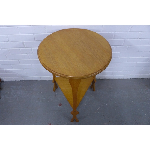 317 - An Arts & Crafts oak table, circular top and underier, 50 x 75cm.