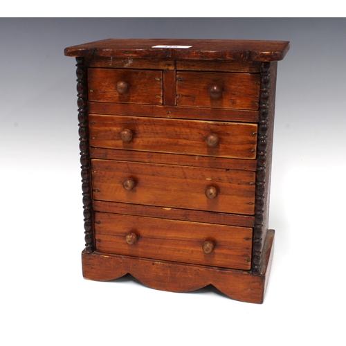 318 - Miniature stained pine chest of drawers with a serpentine top over two short and three graduating lo... 