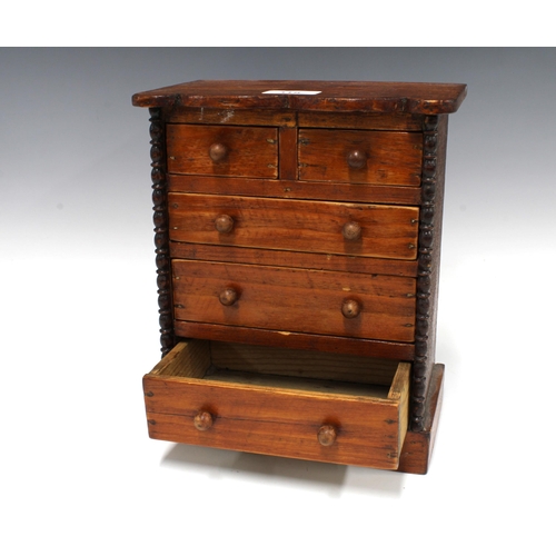 318 - Miniature stained pine chest of drawers with a serpentine top over two short and three graduating lo... 