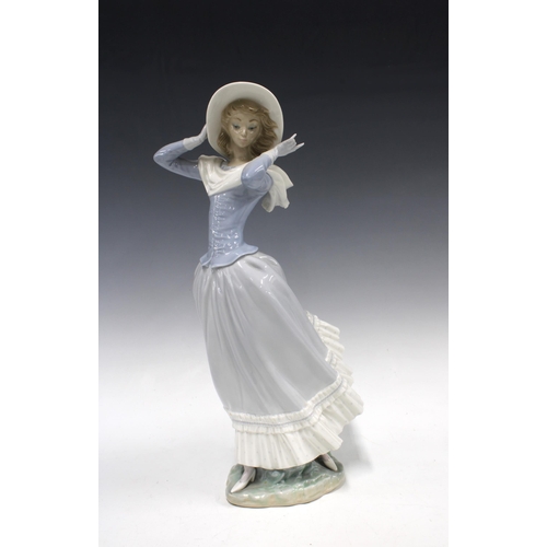 328 - Lladro figure 'Spring Breeze' of a woman holding her hat in the wind, 35cm