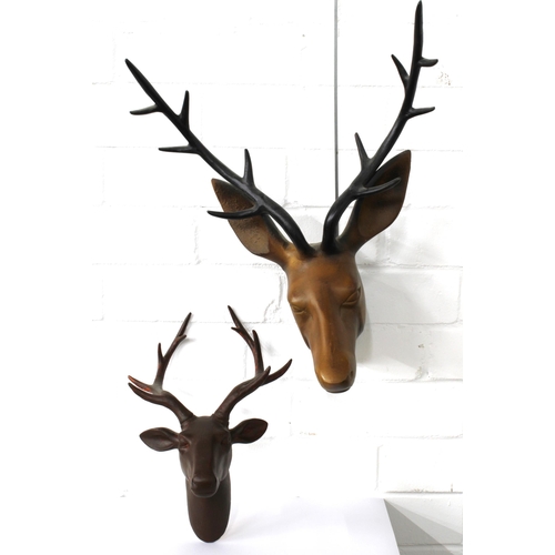 353 - A modern painted metal deer head, 34 x 48cm, together with a smaller brown painted composite deer he... 