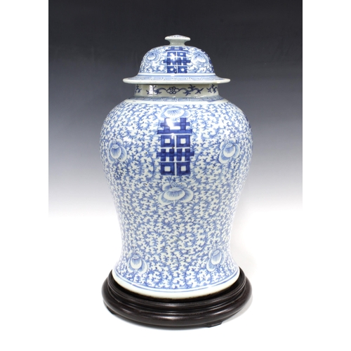 355 - 19th century Qing Dynasty blue and white baluster vase with cover, on a wooden stand, bearing an apo... 