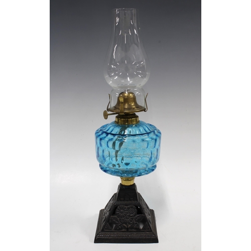 379 - Early 20th century oil lamp with blue glass well, 41cm