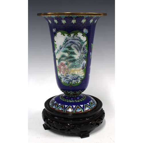 402 - Cloisonne vase with painted panels on a blue field, on wooden stand, 26cm