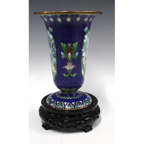 402 - Cloisonne vase with painted panels on a blue field, on wooden stand, 26cm