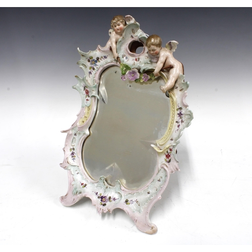 404 - Continental dressing table mirror with puttis and a bevelled glass, 23 x 35cm, a/f with foot repair