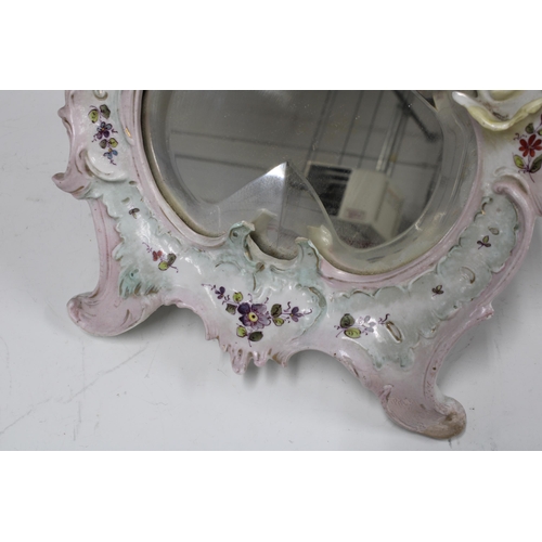 404 - Continental dressing table mirror with puttis and a bevelled glass, 23 x 35cm, a/f with foot repair