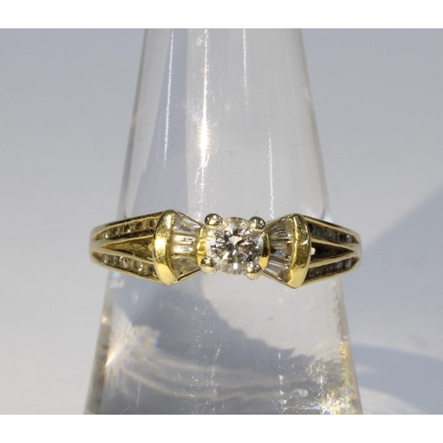 42 - 18ct gold diamond ring, the central bright cut diamond in a four claw setting flanked by three bague... 