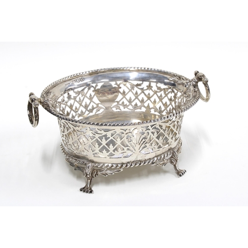 72 - George V silver pierced dish with ring handles and standing in four hoof feet, London 1914, retailed... 