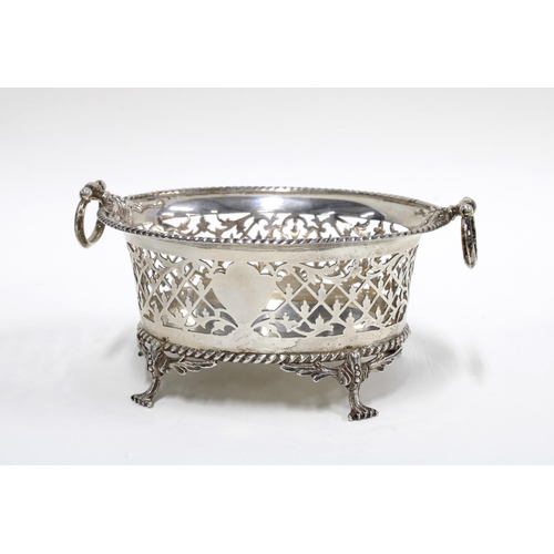 72 - George V silver pierced dish with ring handles and standing in four hoof feet, London 1914, retailed... 