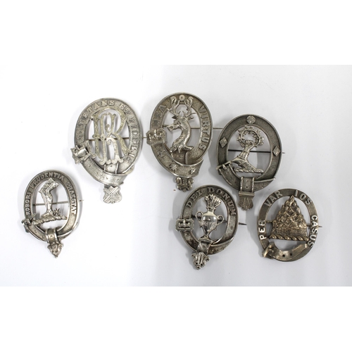 86 - A group of six white metal clan badges, one stamped RS & S, the others unmarked, largest 8cm (6)