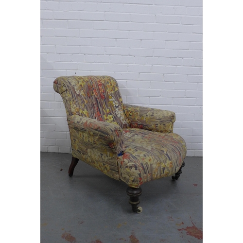 298 - Country House upholstered armchair, with later floral cover, mahogany legs with brass caps and casto... 