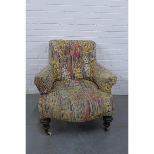 298 - Country House upholstered armchair, with later floral cover, mahogany legs with brass caps and casto... 