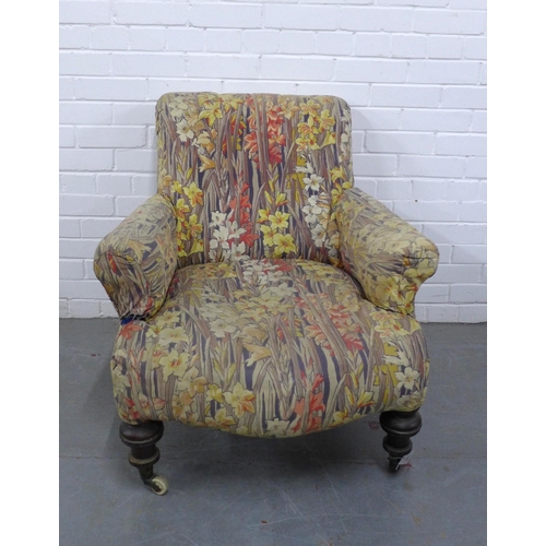 298 - Country House upholstered armchair, with later floral cover, mahogany legs with brass caps and casto... 