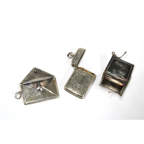 1 - A late Victorian silver vesta case, Chester 900,  a silver stamps case and a miniature silver purse ... 