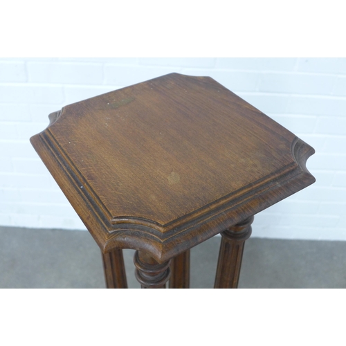 210 - Mahogany torchere/plant stand, square top with canted corners, on four columns, 31 x 106cm.