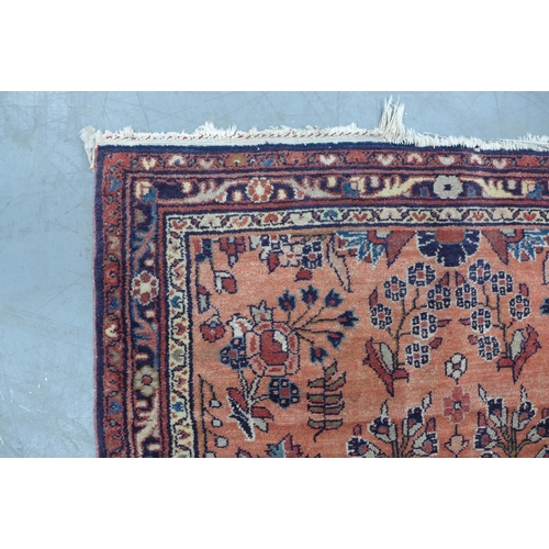 213 - Persian rug with central blue and ivory medallion and a red foliate field, 105 x 21ocm.