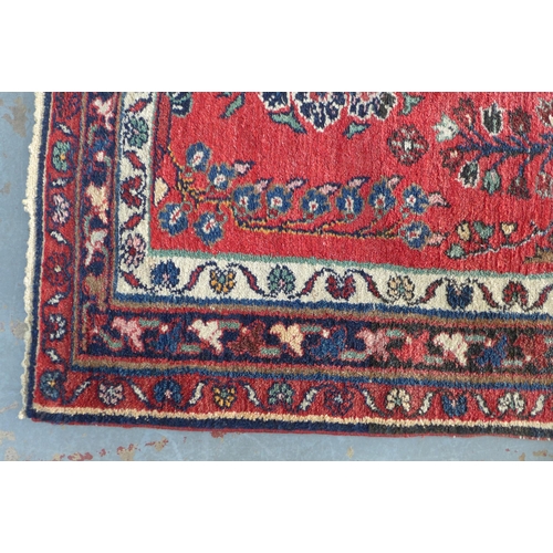 222 - Persian wool rug, red foliate field, 202 x 103cm