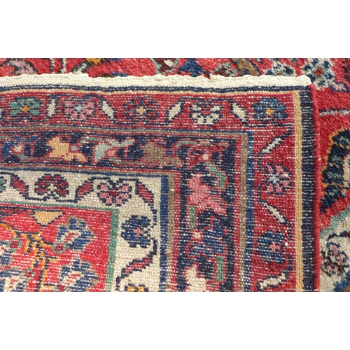 222 - Persian wool rug, red foliate field, 202 x 103cm