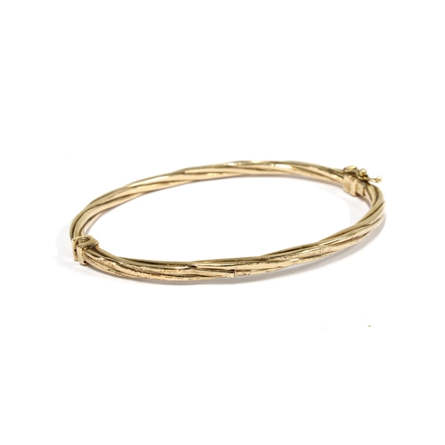 23 - 9ct gold bangle with twisted design, stamped 375