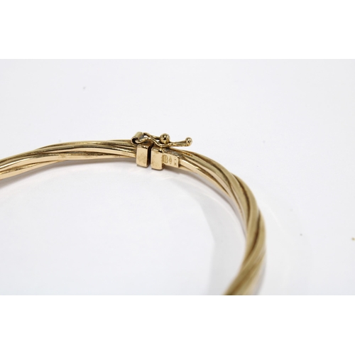 23 - 9ct gold bangle with twisted design, stamped 375