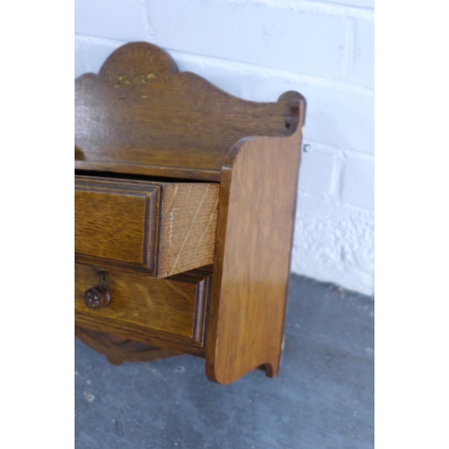 233 - Golf Interest: an oak 'Club Fixtures' wall shelf with four drawers, golf ball and thistle carving, 4... 