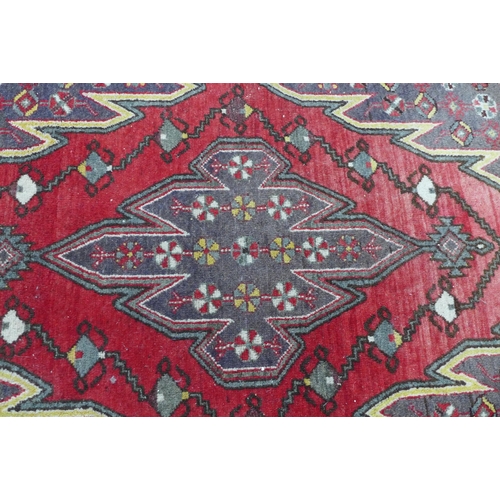 236 - Persian Mazlaghan rug,  central serrated lozenge and madder field, 190 x 131cm