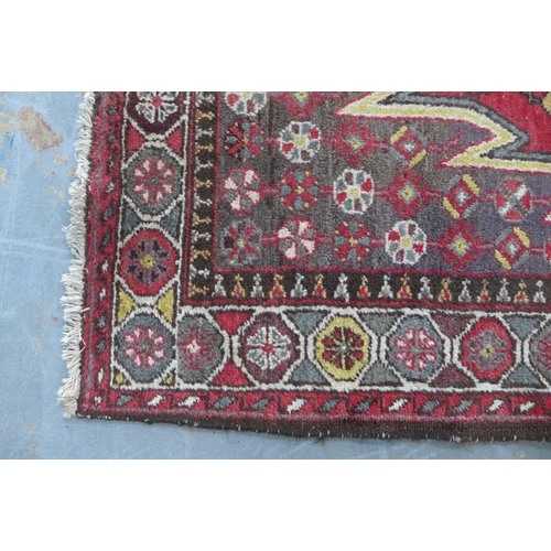 236 - Persian Mazlaghan rug,  central serrated lozenge and madder field, 190 x 131cm