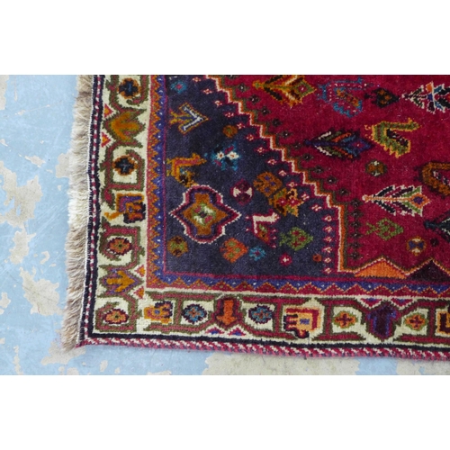 237 - Persian Qashqai rug, red foliate field with central blue medallion,  168 x 88cm