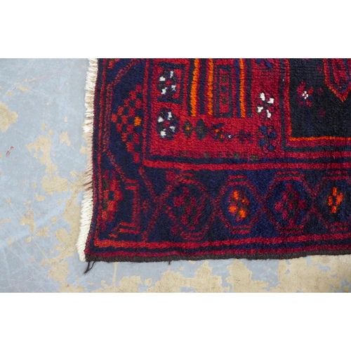 238 - Afghan wool rug, red field and flowerhead border, 188 x 143cm