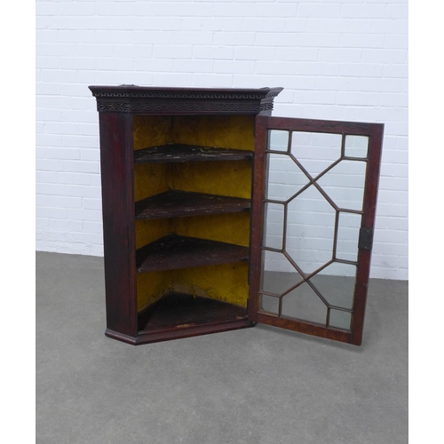 263 - Georgian oak hanging corner cupboard with dentil moulded cornice above a blind fret carved frieze an... 