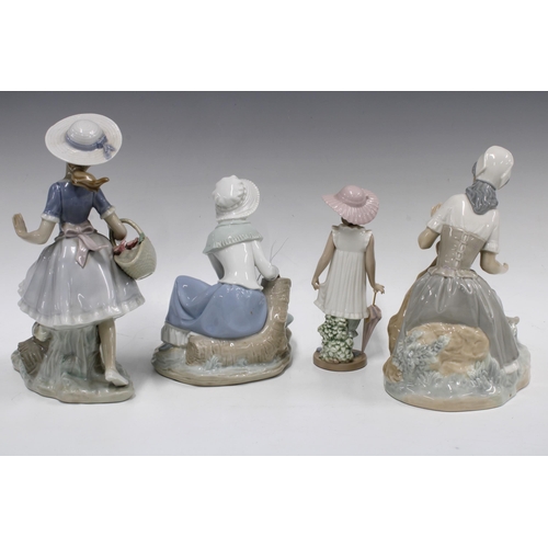 302 - Three Nao figures of girls with animals, together with a Nao girl with umbrella, tallest 26cm (4)