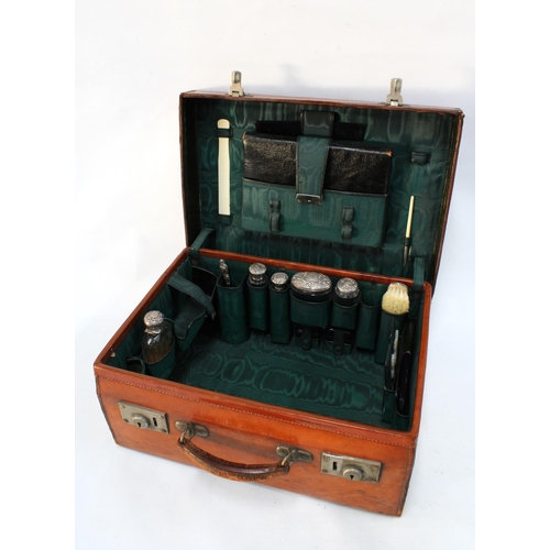 326 - An Edwardian  Walker & Hall brown leather vanity travel case with green silk fitted interior contain... 