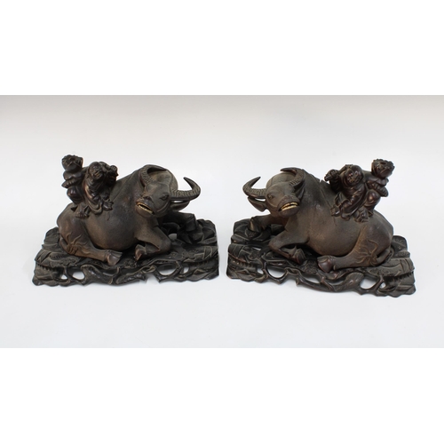 328 - Pair of Chinese carved wooden water buffalo and rider table lamp bases, on stands, with screw fittin... 