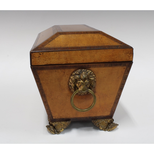 338 - Satinwood sarcophagus tea caddy, with crossbanded edging, ormolu lion face handles and paw feet (ben... 