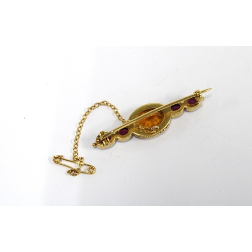 66 - A citrine and rhodolite brooch, set in unmarked yellow metal, with safety chain, boxed, 4cm