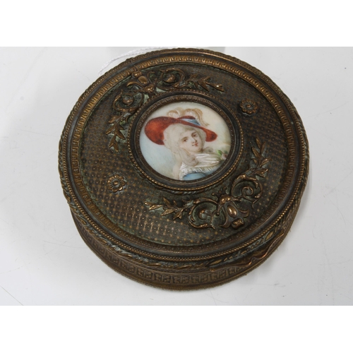 80 - An early 20th century brass trinket box, the cover with a handpainted ivorine plaque, 9cm