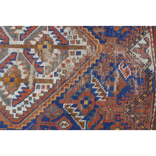 217 - Persian rug with three medallions and a worn red field, multiple borders, 207 x 152cm