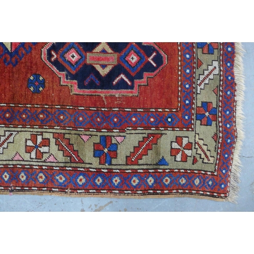 219 - Persian rug, red field with central blue medallion, 198 x 146cm