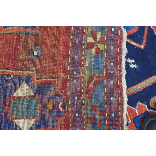 219 - Persian rug, red field with central blue medallion, 198 x 146cm