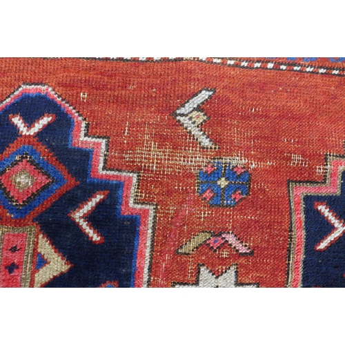 219 - Persian rug, red field with central blue medallion, 198 x 146cm