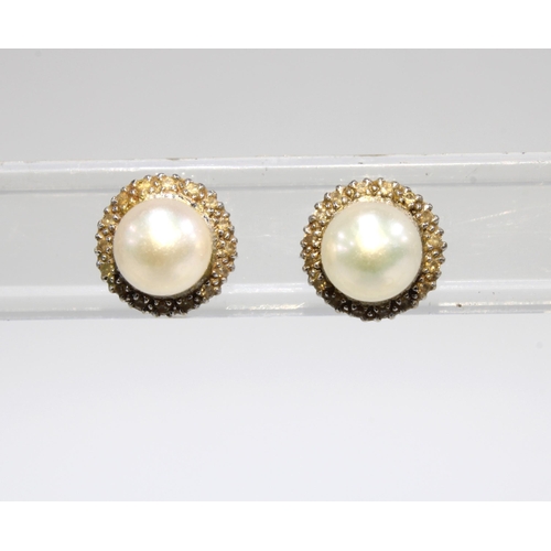 20 - A pair of vintage cultured pearl stud earrings, yellow metal posts (2)