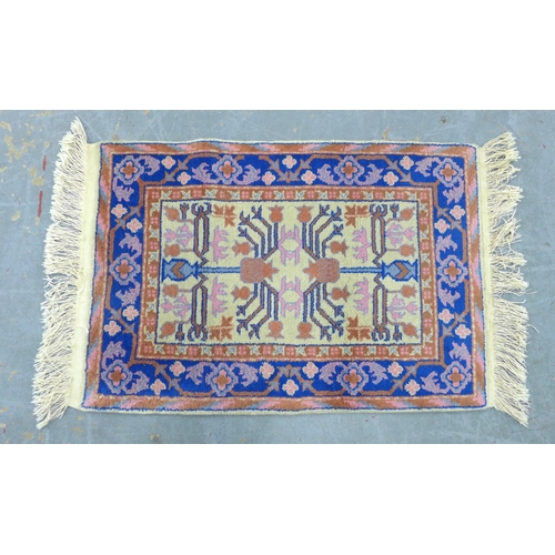 290 - Small wool rug, pomegranate pattern in pink and blue on a cream field, 90 x 62cm