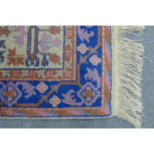 290 - Small wool rug, pomegranate pattern in pink and blue on a cream field, 90 x 62cm